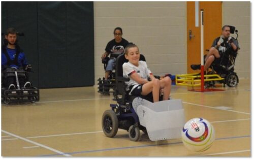Chile in wheelchair pushes soccer ball